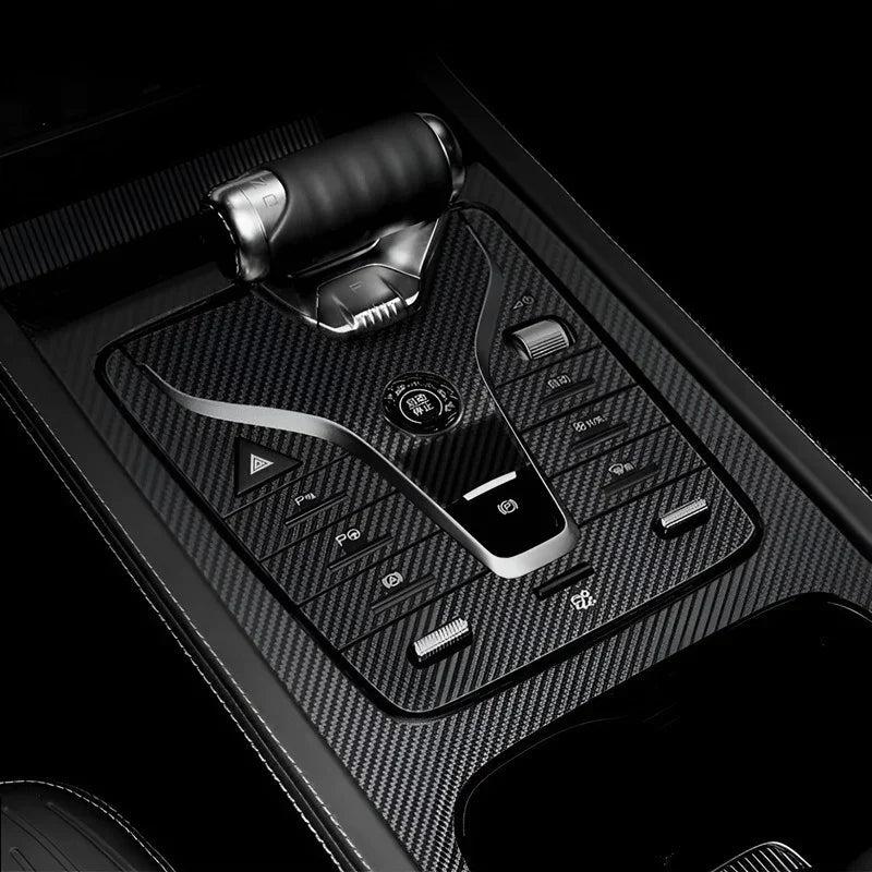 Black carbon fiber center console gear shift panel with professional sleek textured finish.
