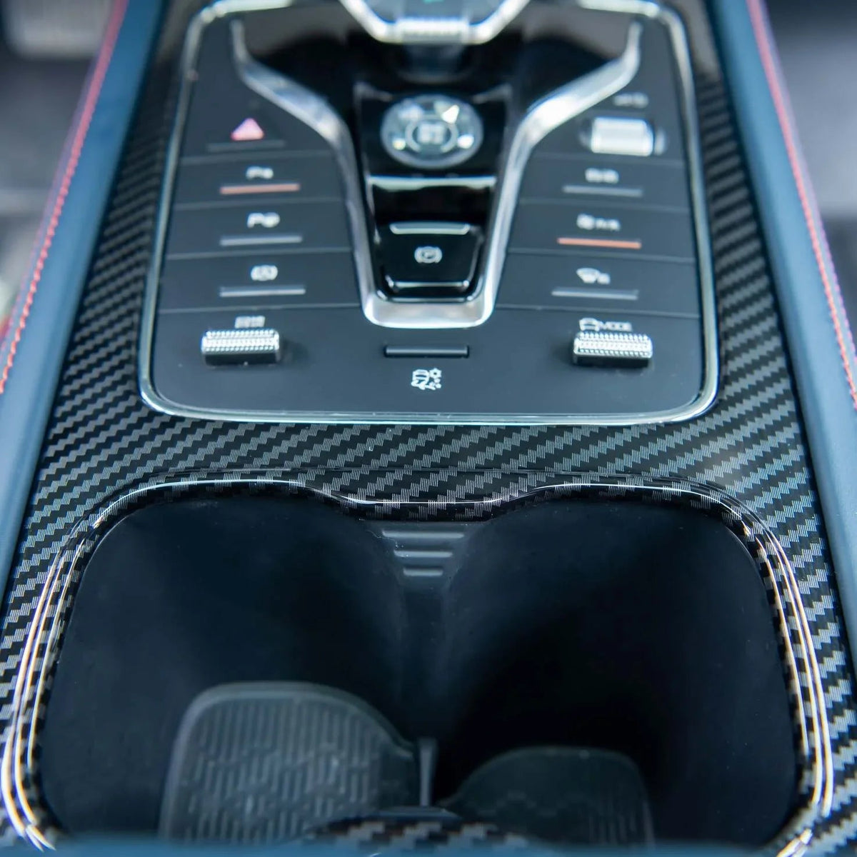 Center console with carbon fiber trim and blue leather with red stitching for BYD.