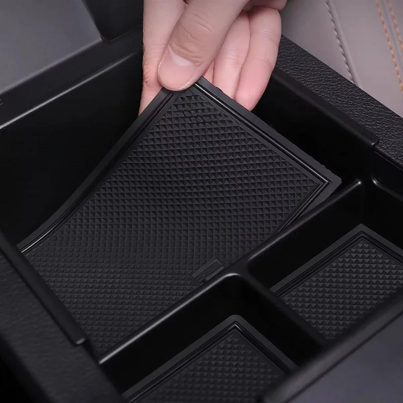 Black textured non-slip silicone organizer tray for car center console storage.