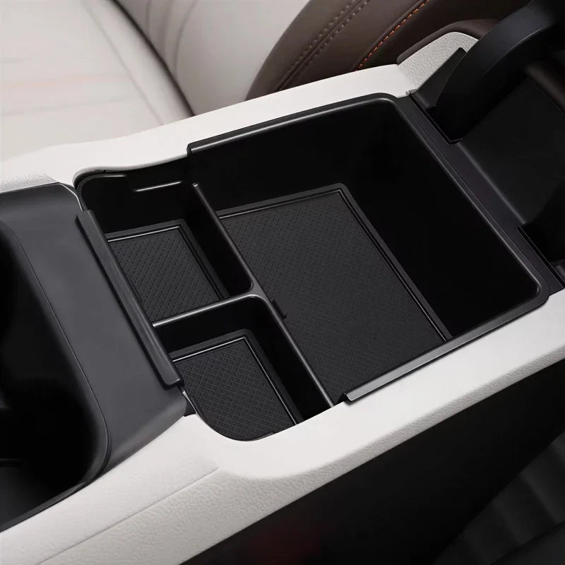 Black custom-fit EVA organizer tray for car center console, providing durable storage protection.