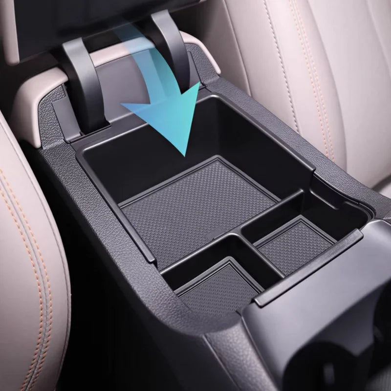 Black textured plastic center console organizer tray for BYD car interior storage.