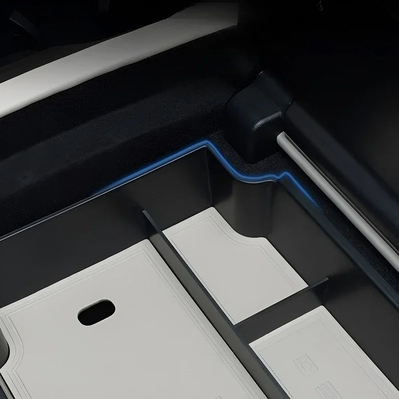 Close-up of a professional black custom-fit car floor mat with durable synthetic material.