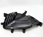 Glossy black automotive front grille insert with a sleek, ribbed design.