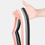 Hand holding a set of professional latex resistance bands in pink, white, grey, and black.