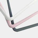 Close-up of durable metal frames in white, pink, and charcoal grey finishes.