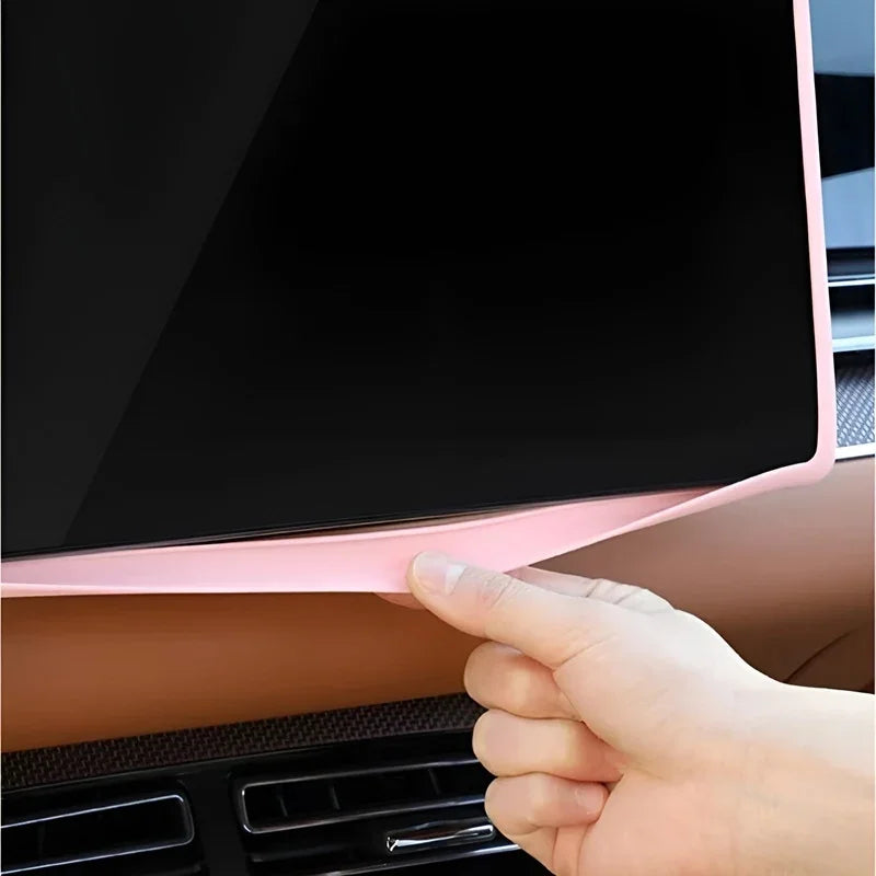Close-up of a pink soft silicone protective trim for a car infotainment screen