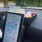Black matte plastic car organizer tray holding tissues and small accessories next to a BYD tablet.