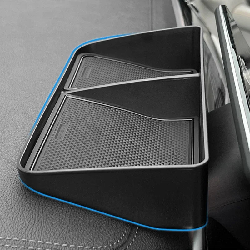 Black dual-compartment car center console organizer tray with blue trim edges.