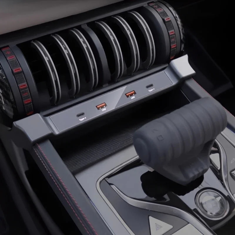 Close-up of a modern car interior featuring a sleek black center console with USB ports and a grey gear shifter.