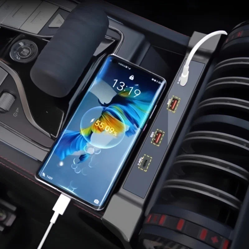 Smartphone charging via USB cable in a car console next to a black gear shifter.