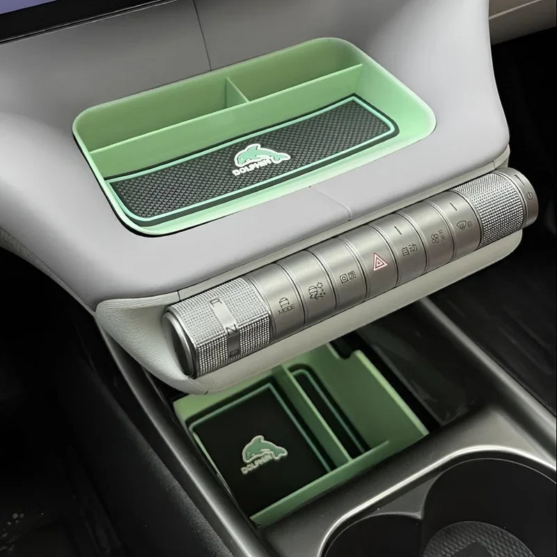 Green and black BYD aftermarket console organizer tray with dolphin logo for car storage