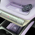 Light purple BYD Dolphin interior with silver metallic control buttons and car key in tray.