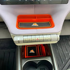 Orange and black carbon fiber texture interior organizer tray for BYD Dolphin.