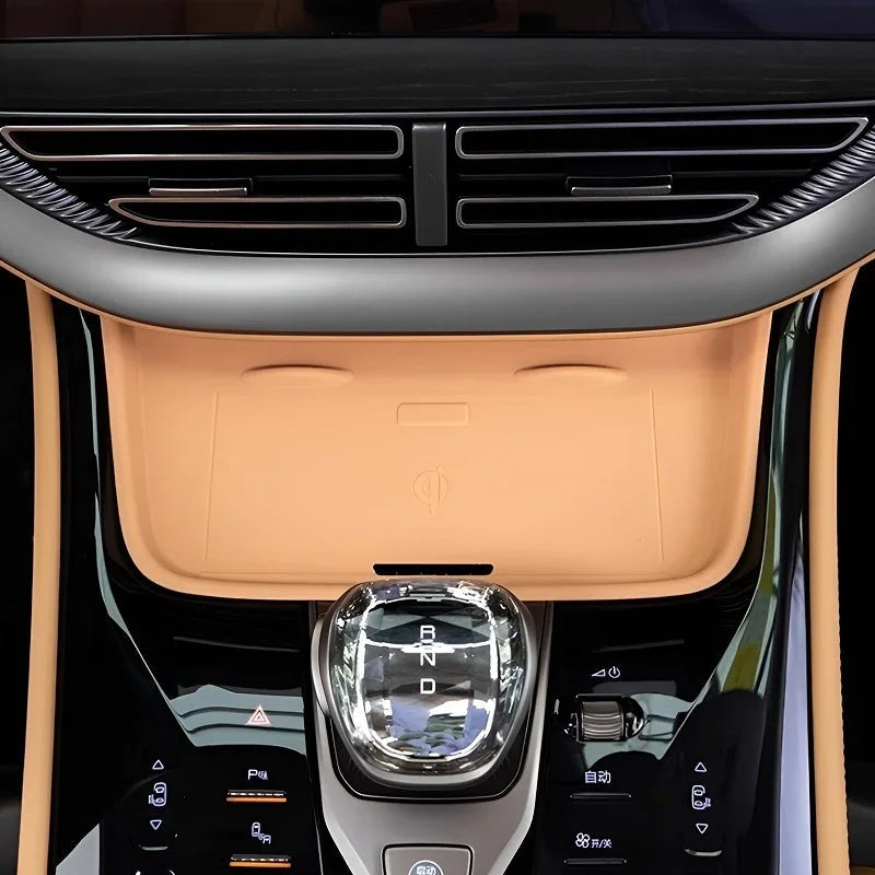 Tan leather center console cover and chrome gear shifter for BYD interior protection.