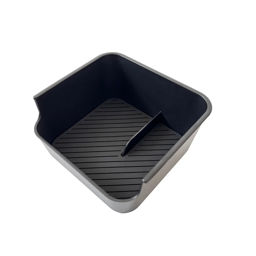 Black matte plastic car center console organizer tray with non-slip ribbed texture.