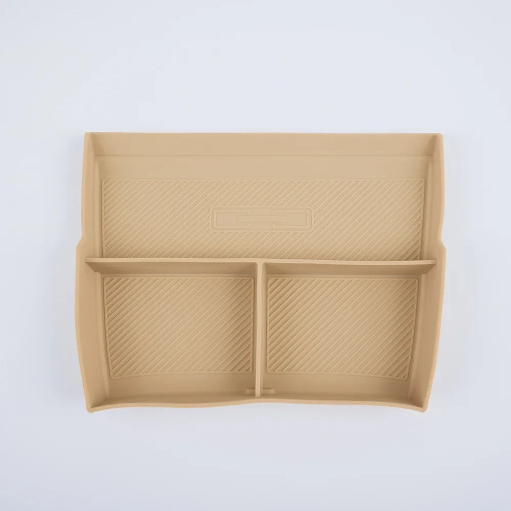 Tan silicone car center console organizer tray with anti-slip ribbed texture.
