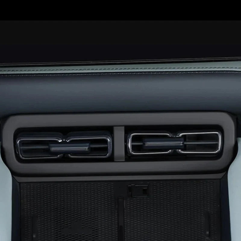 Dual black matte air conditioning vents with sleek chrome-finished trim for BYD interior.