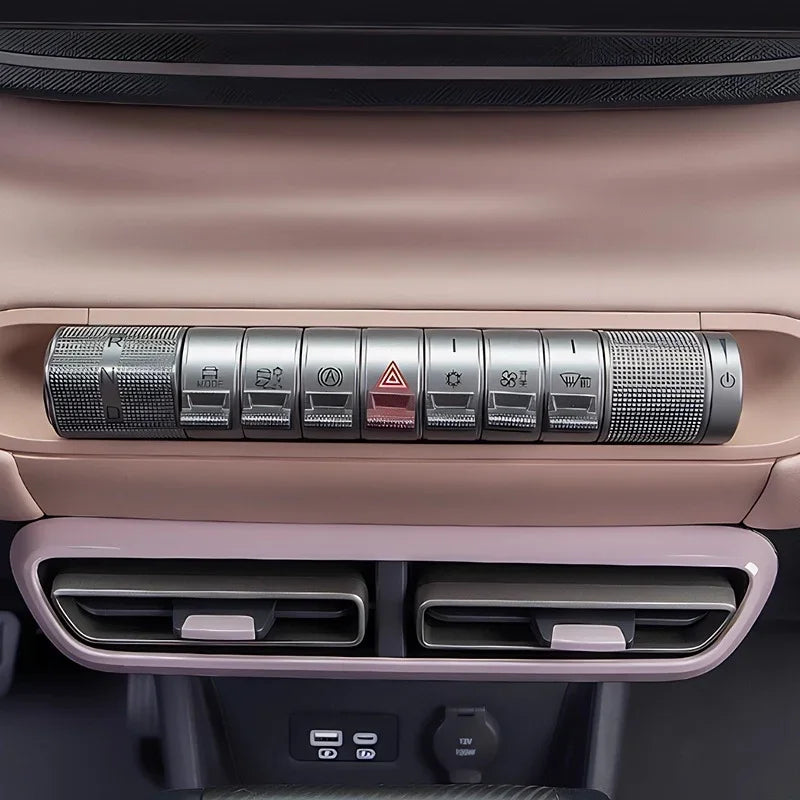 Silver metallic dashboard control panel with textured buttons and sleek interior finish.