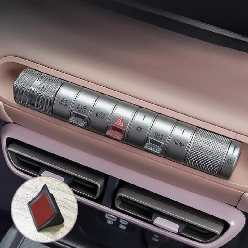 Red textured protective cover for the car hazard light switch on a BYD dashboard.