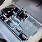 Glossy black crystal gear shifter with RND indicator and silver metallic control knobs.