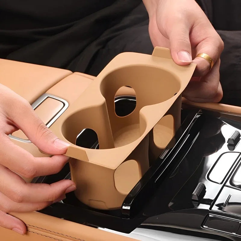 Tan silicone dual cup holder expander insert for car center console.