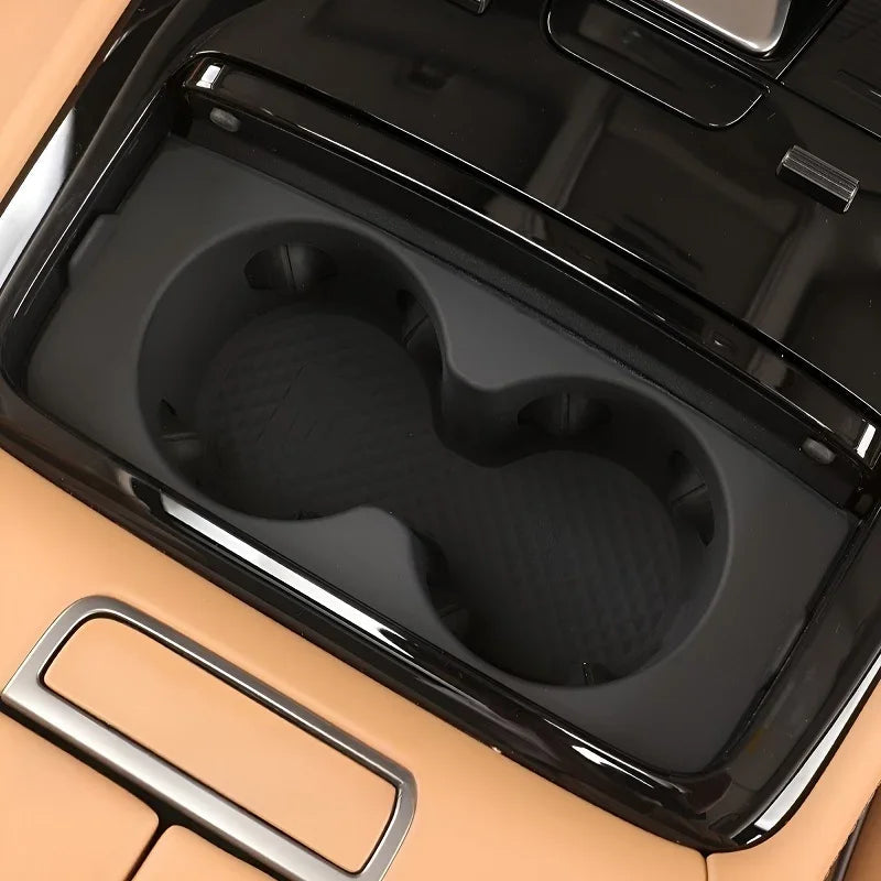 Black protective cup holder liner for BYD vehicle interior with textured surface.