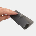 Hand holding a flexible grey silicone car accessory protector