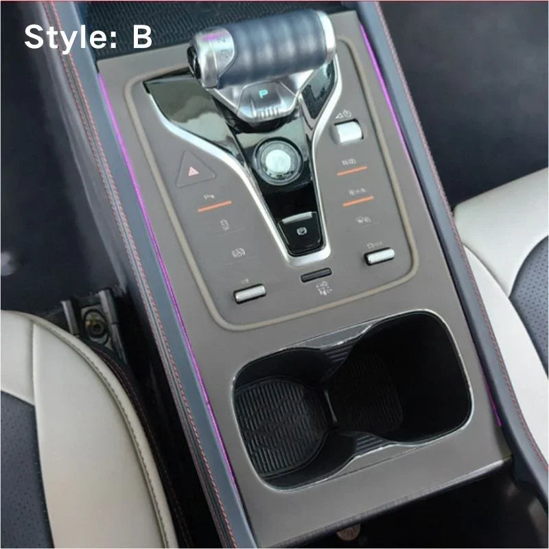 Grey center console trim with sleek metallic finish and purple ambient lighting accents.