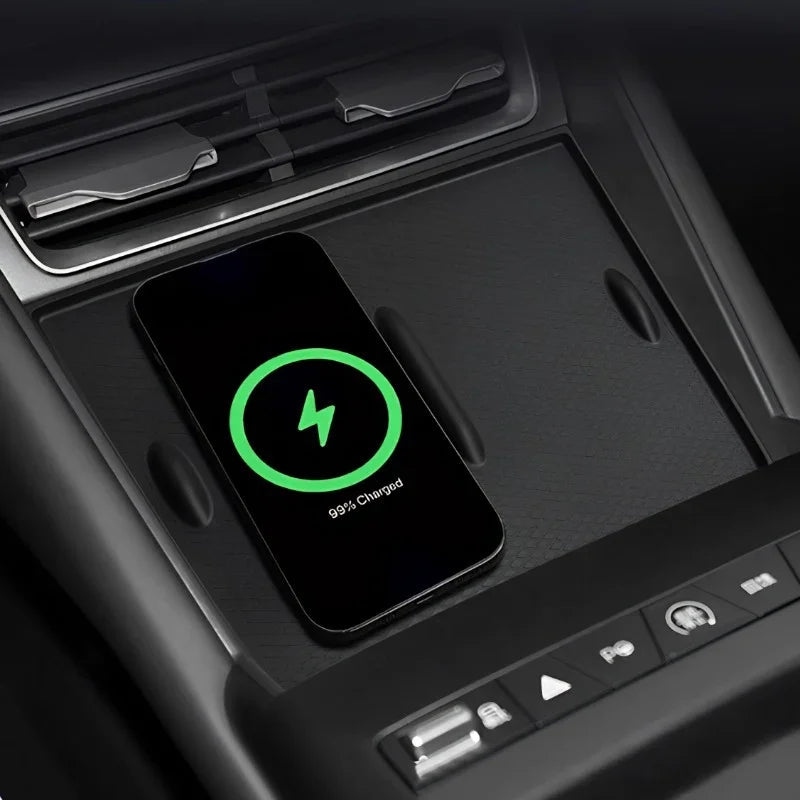 Black textured car console mat with a smartphone wirelessly charging on the surface.