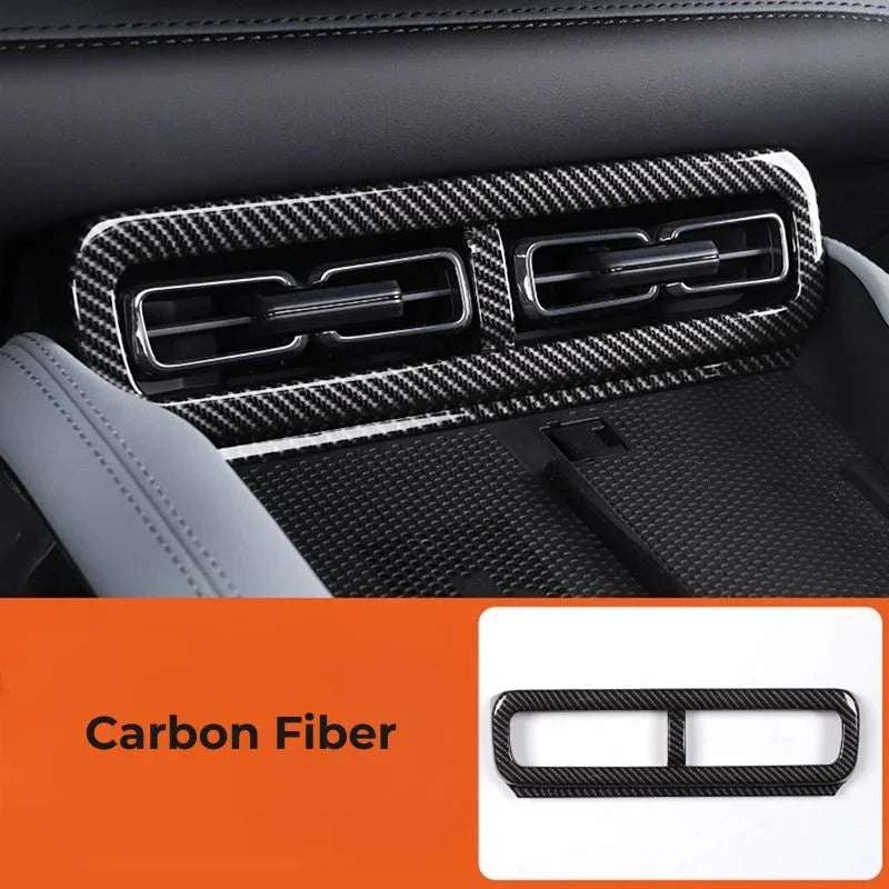 Black carbon fiber air vent trim cover for BYD interior enhancement.