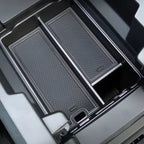 Black textured silicone center console organizer tray for BYD car interior protection.