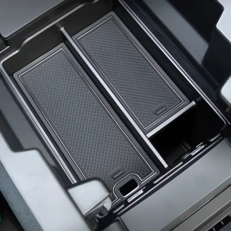 Black textured silicone center console organizer tray for BYD car interior protection.