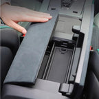 Grey suede center console organizer box for car interior storage.