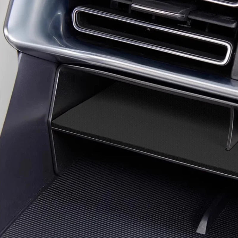 Black carbon fiber texture center console storage tray for BYD vehicle interior.