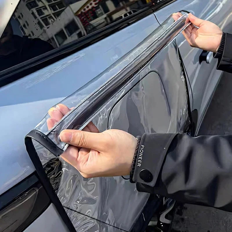 Applying a clear, protective TPU film to a silver car door to prevent scratches and wear.