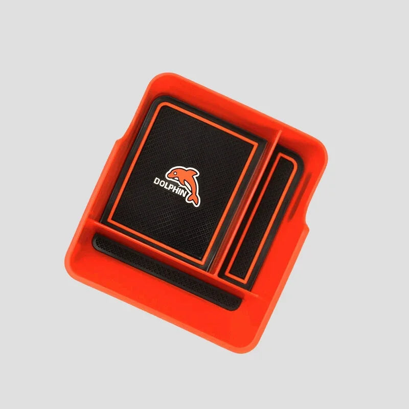Red custom-fit car center console tray with black non-slip surface and Dolphin logo.