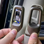 Metallic bronze BYD seatbelt buckle cover with a crystal-like decorative inlay.