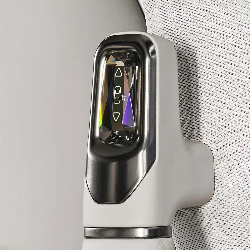 Close-up of a white BYD electric vehicle charging port with a sleek metallic finish and glowing indicator light.