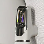 Close-up of a white BYD electric vehicle charging port with a sleek metallic finish and glowing indicator light.