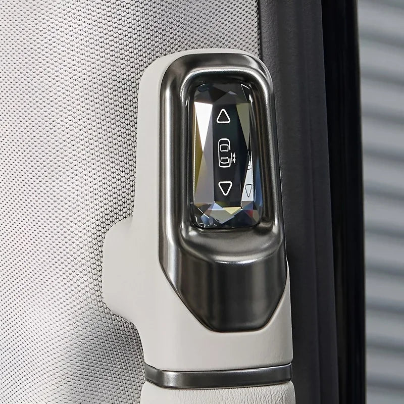 Close-up of a sleek white and metallic silver window control switch on a car door panel.