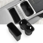 Black durable plastic center console organizers for BYD, including a storage tray and cup holder.