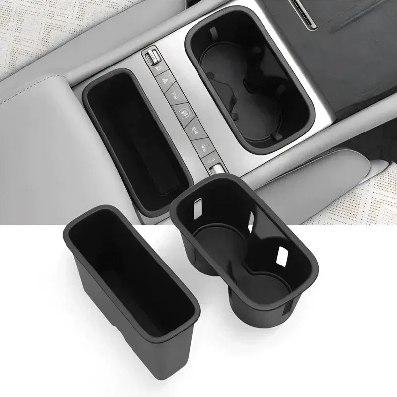 Black durable plastic center console organizers for BYD, including a storage tray and cup holder.