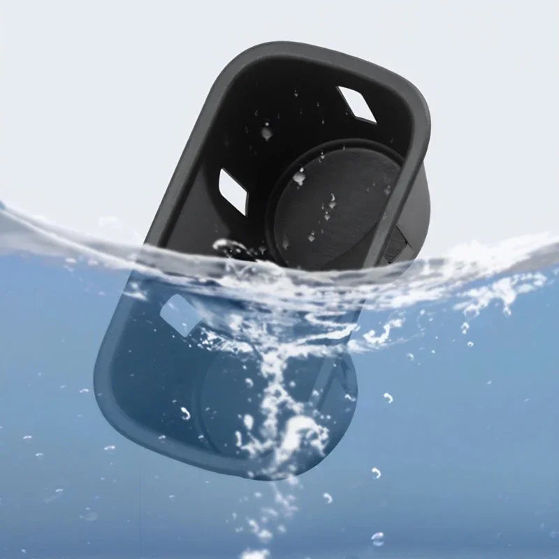 Waterproof black matte car cup holder accessory partially submerged in clear splashing water.