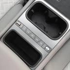 Silver center console with black dual cup holders and integrated storage tray for BYD models.