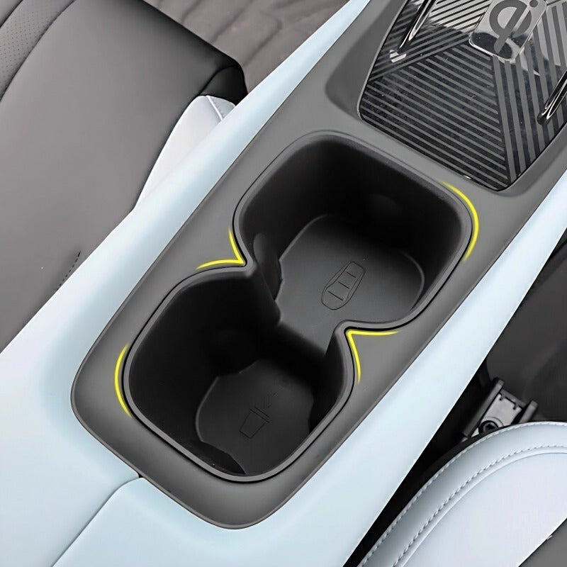 Black center console cup holder with yellow accent lines for BYD interior.