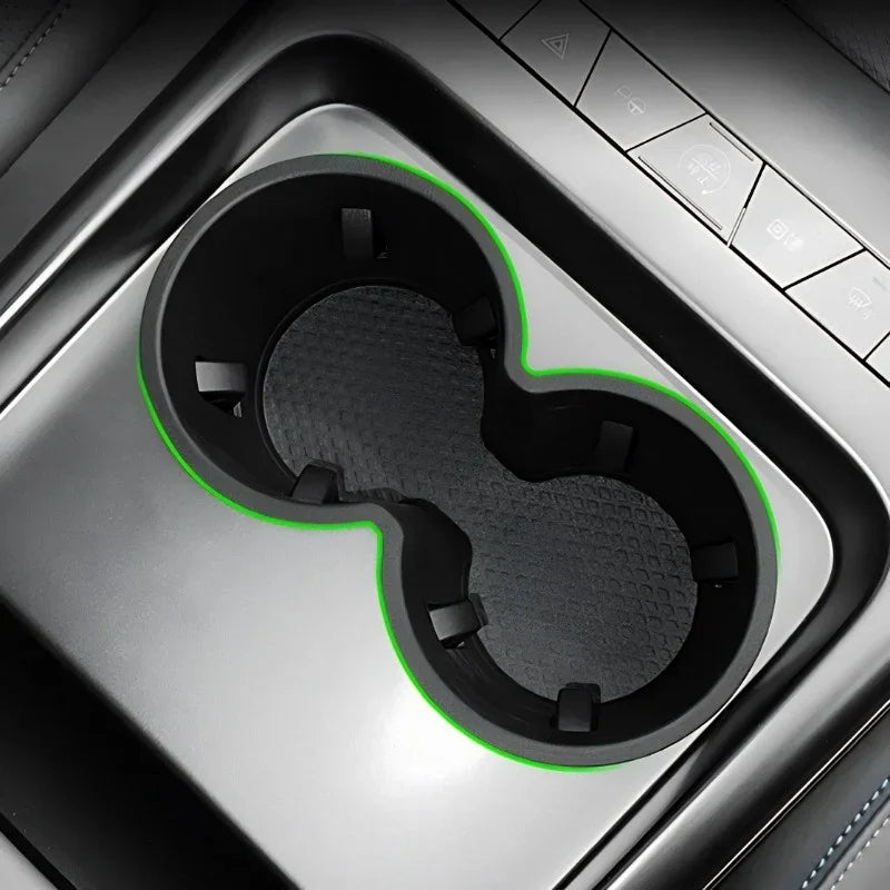 Black dual car cup holder organizer with vibrant green trim and textured non-slip surface.