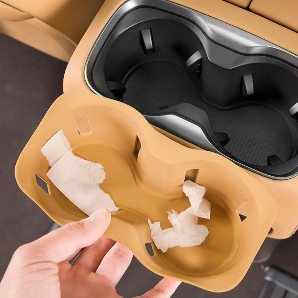 Tan beige flexible silicone car cup holder organizer insert with white tissue paper.