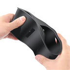 Flexible black matte silicone car cup holder organizer being demonstrated for durability.