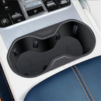 Black matte durable plastic dual cup holder insert for car center console.