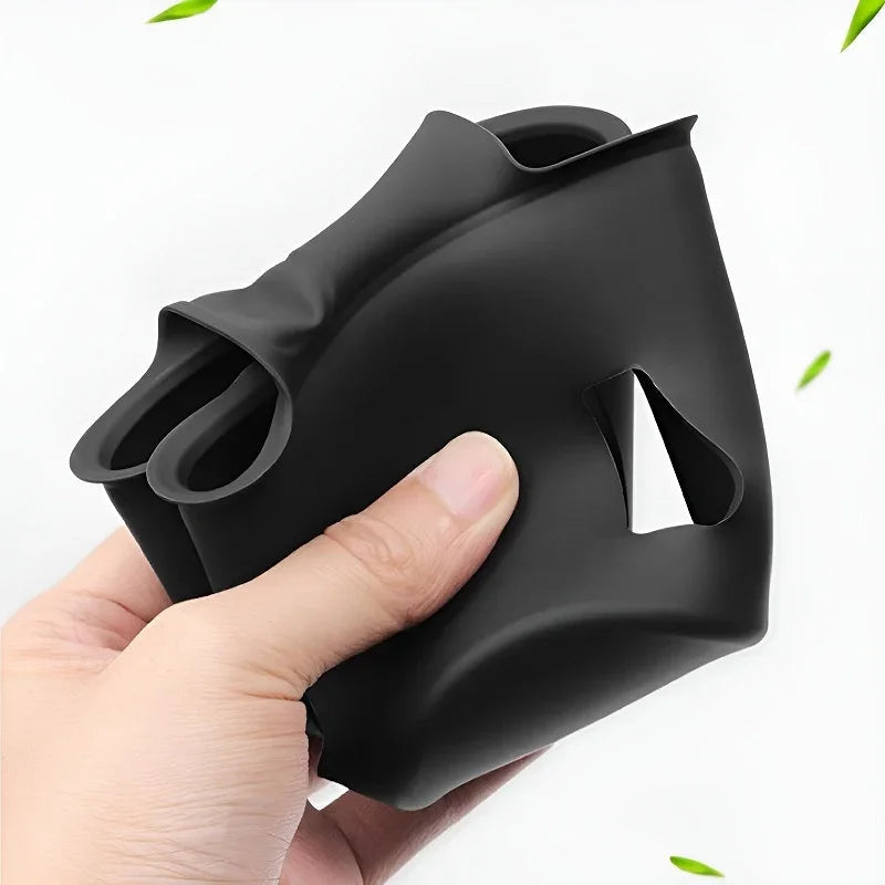 Hand holding a flexible, matte black silicone automotive accessory with a precise cutout design.